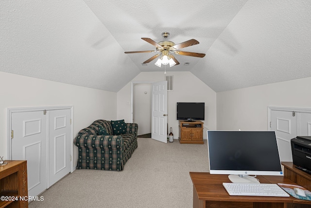 office space featuring a textured ceiling, ceiling fan, lofted ceiling, and light carpet