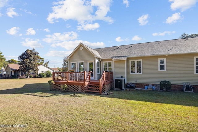 back of house featuring a lawn, a wooden deck, and central AC