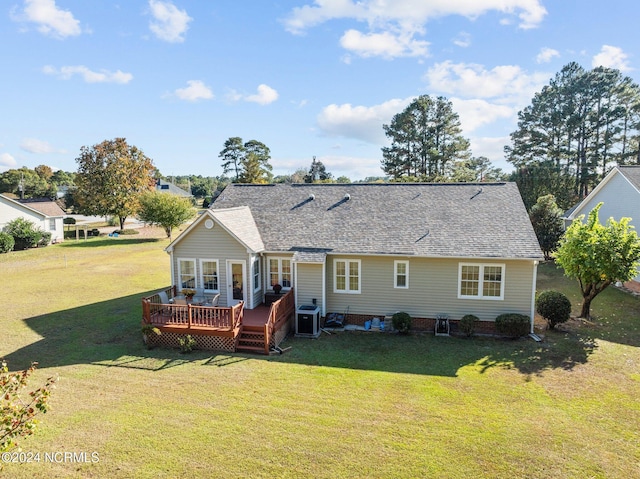 rear view of property with central air condition unit, a deck, and a lawn