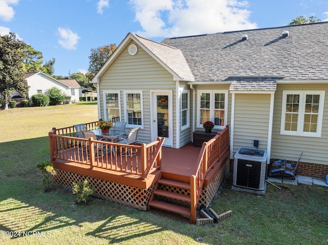 wooden terrace featuring central air condition unit and a lawn