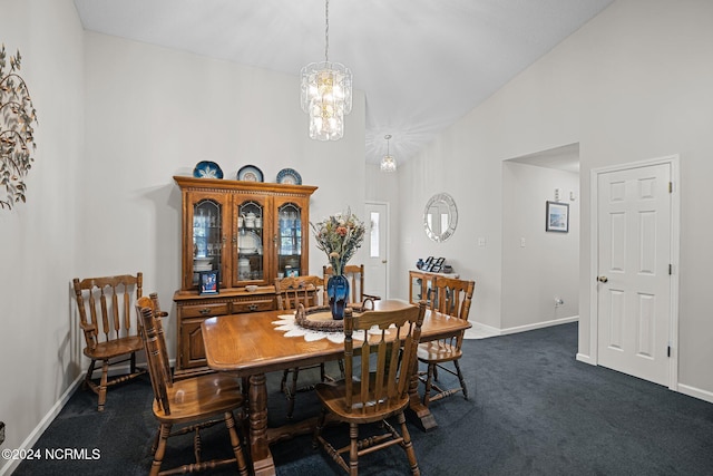 carpeted dining room with high vaulted ceiling and a chandelier