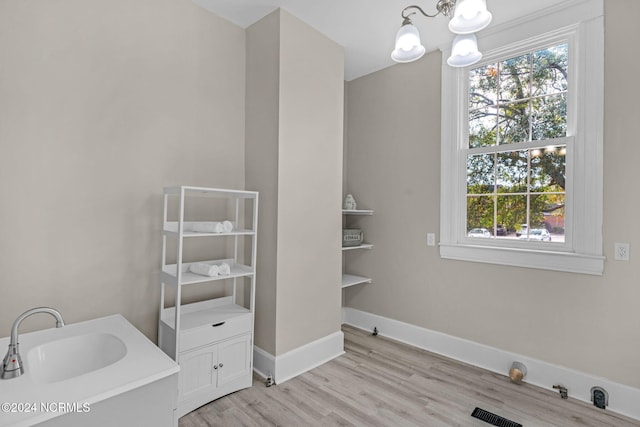 bathroom with vanity, a notable chandelier, and hardwood / wood-style floors