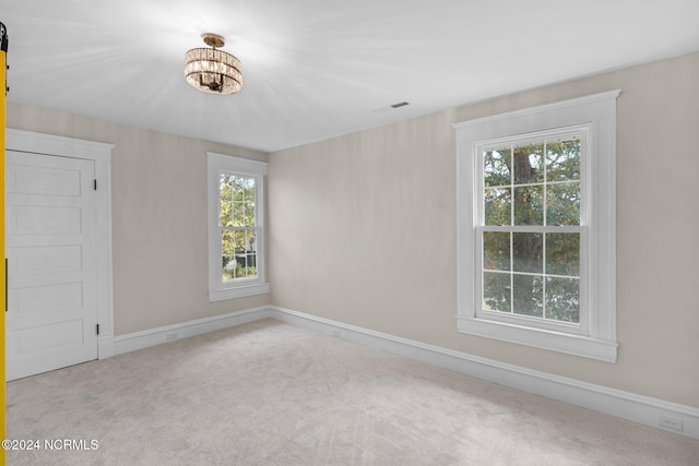 carpeted empty room with plenty of natural light