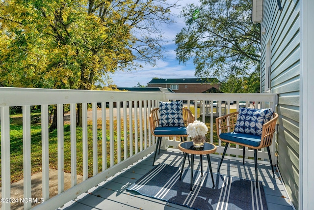 wooden deck featuring a lawn