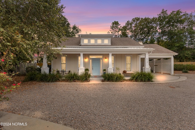 view of front of house with a carport and a porch