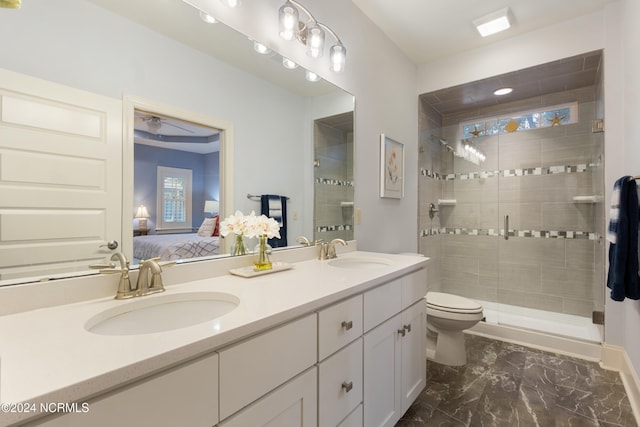 bathroom featuring vanity, toilet, and a shower with door