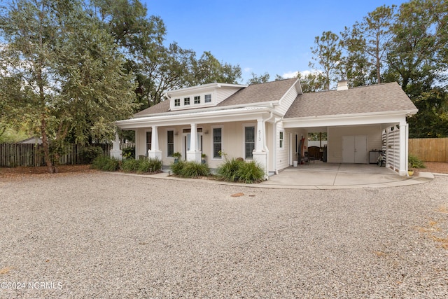 view of front of property featuring covered porch and a carport