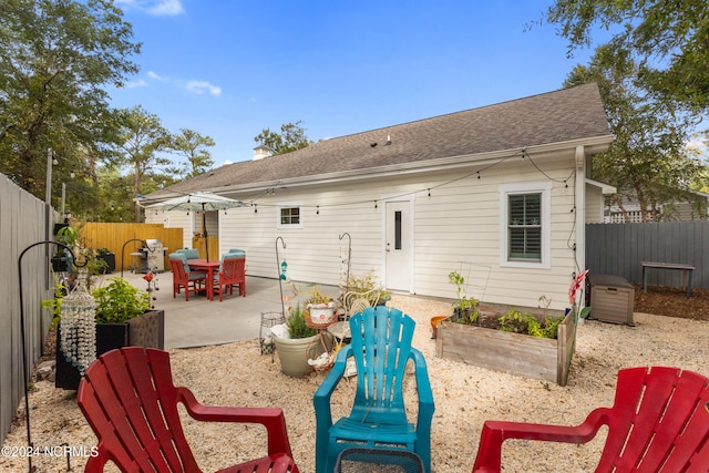 back of house with a patio