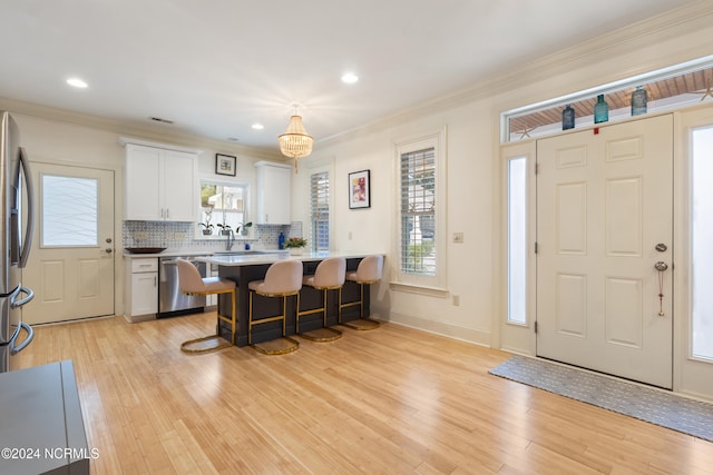 interior space featuring crown molding and light wood-type flooring