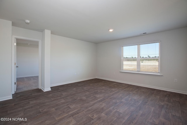 spare room with dark wood-type flooring