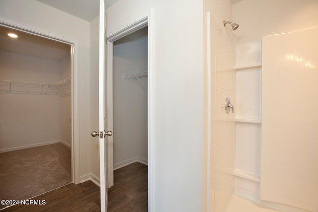 bathroom with hardwood / wood-style floors and walk in shower