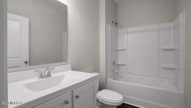 full bathroom featuring tub / shower combination, toilet, and vanity