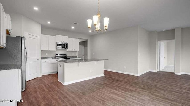 kitchen with white cabinets, stainless steel appliances, a chandelier, and a kitchen island with sink