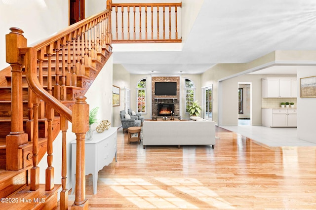 living room featuring light wood-type flooring and a fireplace