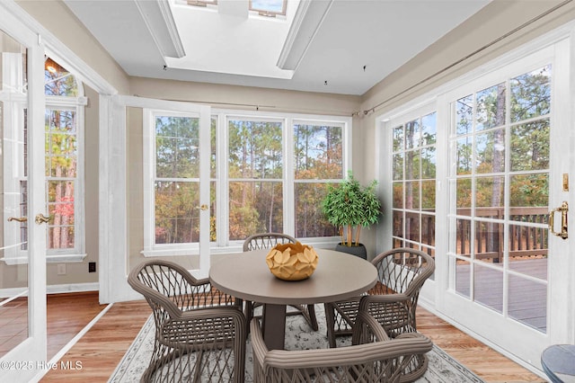 sunroom with a skylight and french doors