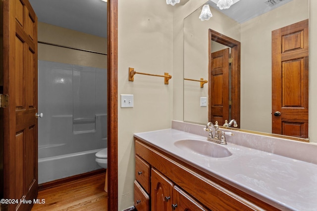 full bathroom featuring vanity, toilet, wood-type flooring, and shower / washtub combination