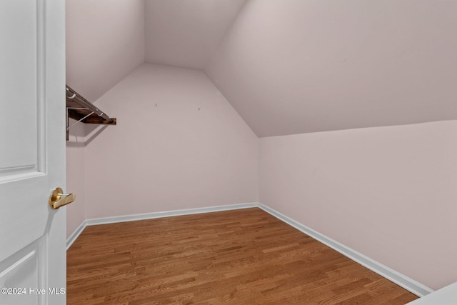 spacious closet with wood-type flooring and lofted ceiling