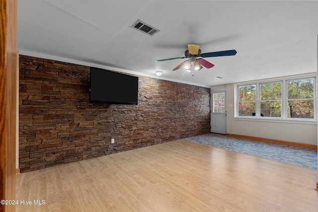 unfurnished living room featuring ceiling fan and light hardwood / wood-style flooring