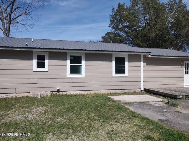 view of property exterior featuring a lawn