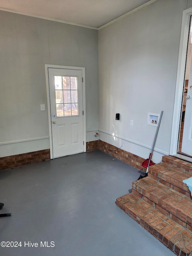 interior space with concrete floors and crown molding