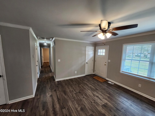 foyer entrance with ornamental molding, dark wood-type flooring, and ceiling fan