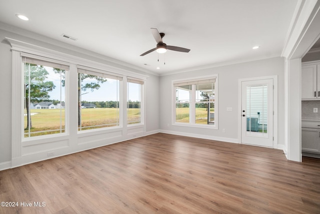 unfurnished living room with ornamental molding, light hardwood / wood-style flooring, and ceiling fan