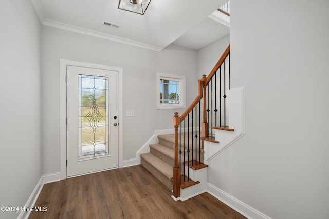 entryway with hardwood / wood-style floors and ornamental molding