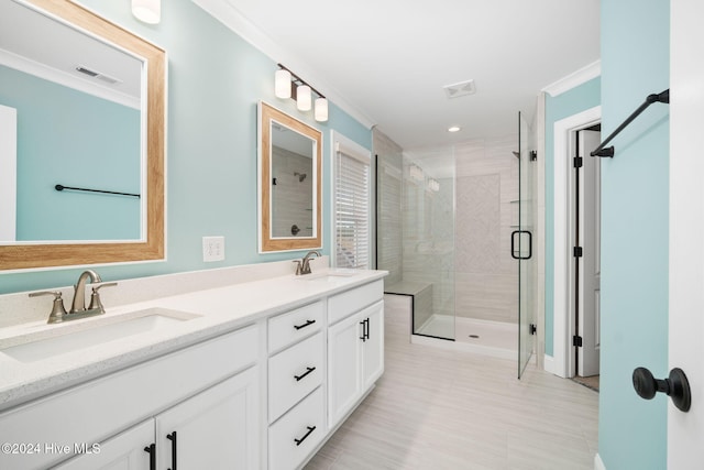 bathroom featuring ornamental molding, vanity, and a shower with shower door