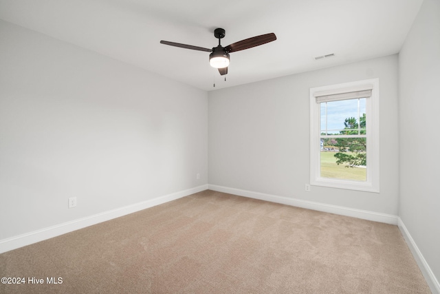 unfurnished room featuring ceiling fan and light carpet