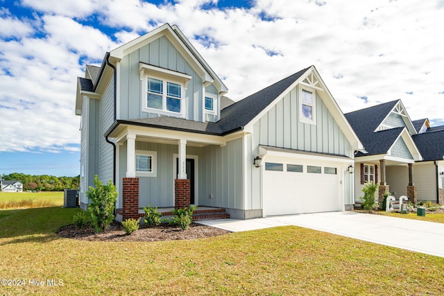 craftsman-style home featuring central air condition unit, a porch, a front yard, and a garage