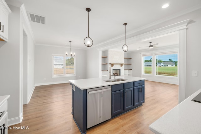 kitchen featuring a kitchen island with sink, a wealth of natural light, stainless steel dishwasher, and blue cabinetry