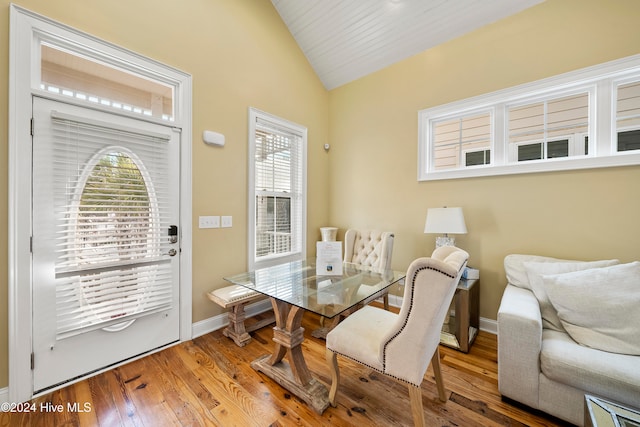 dining area with lofted ceiling and hardwood / wood-style flooring