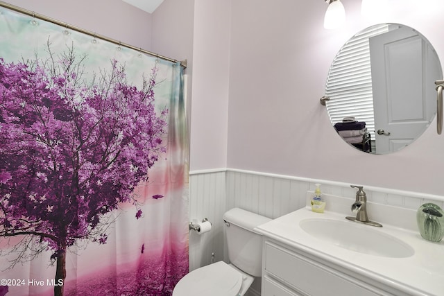 bathroom featuring toilet and vanity