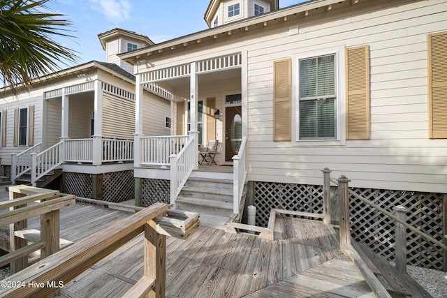 property entrance with a deck