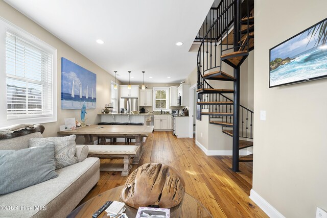 living room featuring sink and light hardwood / wood-style flooring