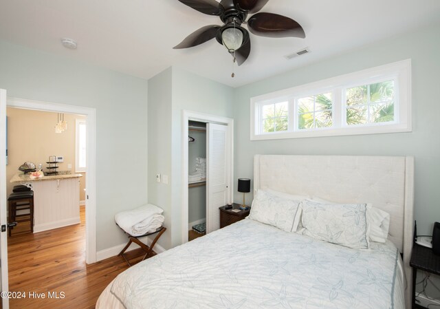 bedroom featuring a closet, ceiling fan, and wood-type flooring