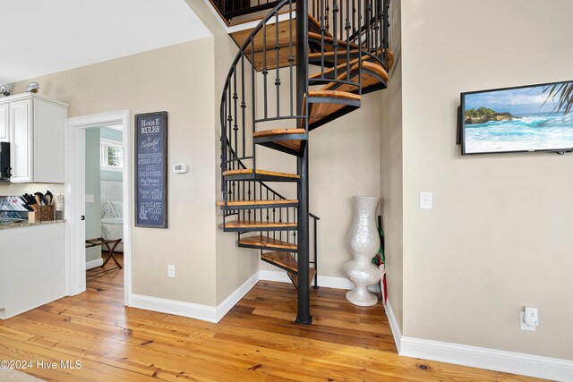 stairs with hardwood / wood-style flooring