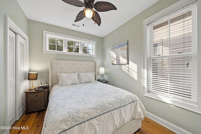 bedroom with wood-type flooring, a closet, and ceiling fan