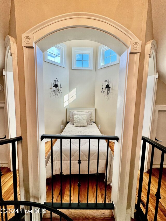 interior space featuring hardwood / wood-style floors, multiple windows, and an inviting chandelier