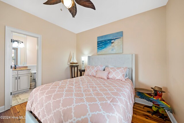 bedroom featuring ensuite bath, wood-type flooring, and ceiling fan