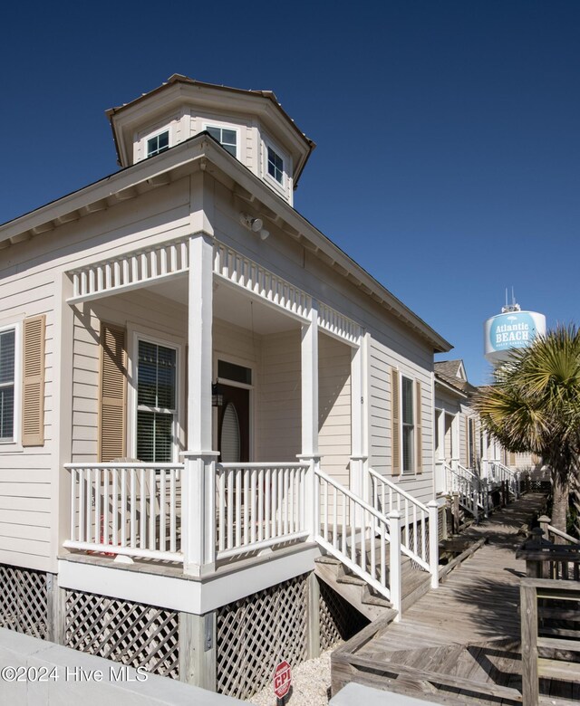 view of side of home featuring a porch