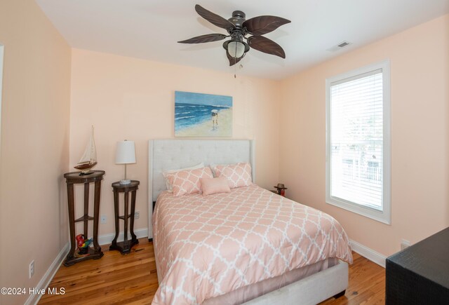 bedroom with light hardwood / wood-style flooring and ceiling fan