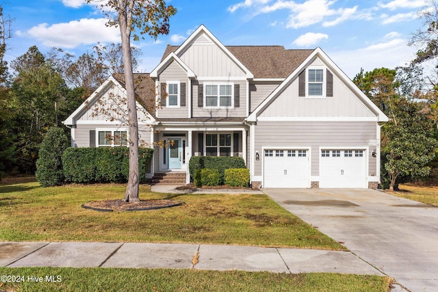 craftsman house featuring a garage and a front lawn