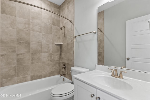 full bathroom featuring vanity, toilet, and tiled shower / bath combo