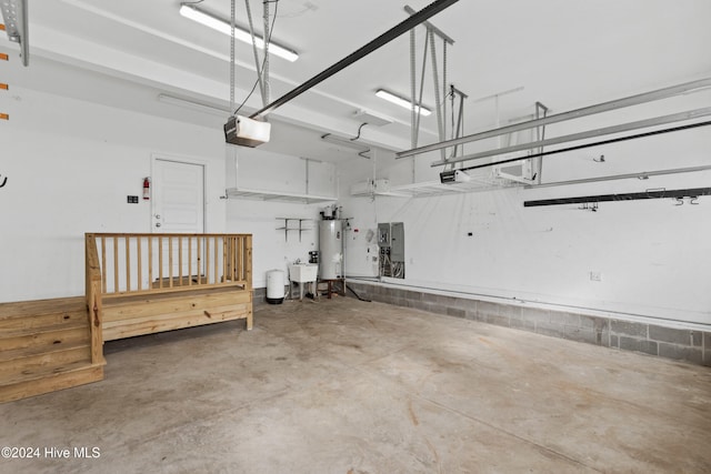 garage with water heater, a garage door opener, and sink