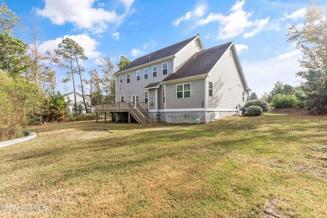 rear view of property featuring a yard and a deck