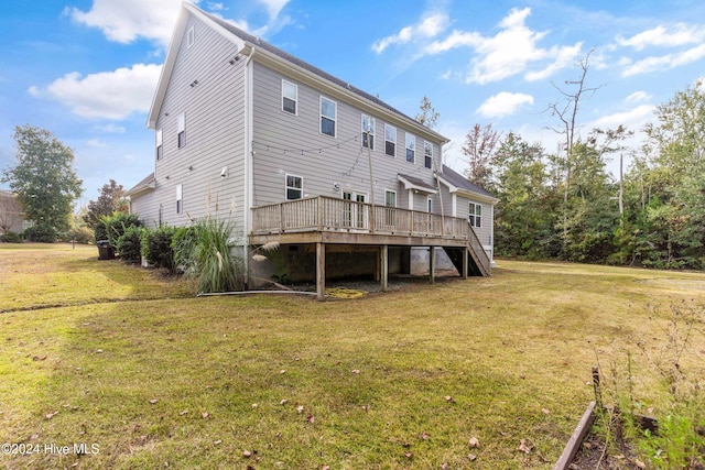 rear view of property with a lawn and a deck