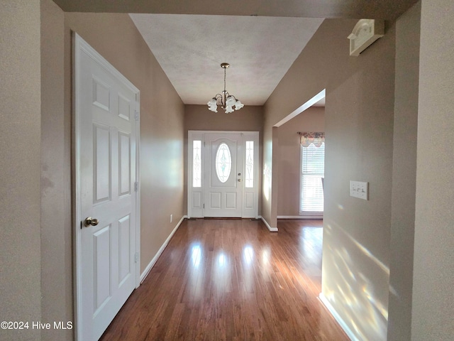 entryway with a notable chandelier and hardwood / wood-style floors