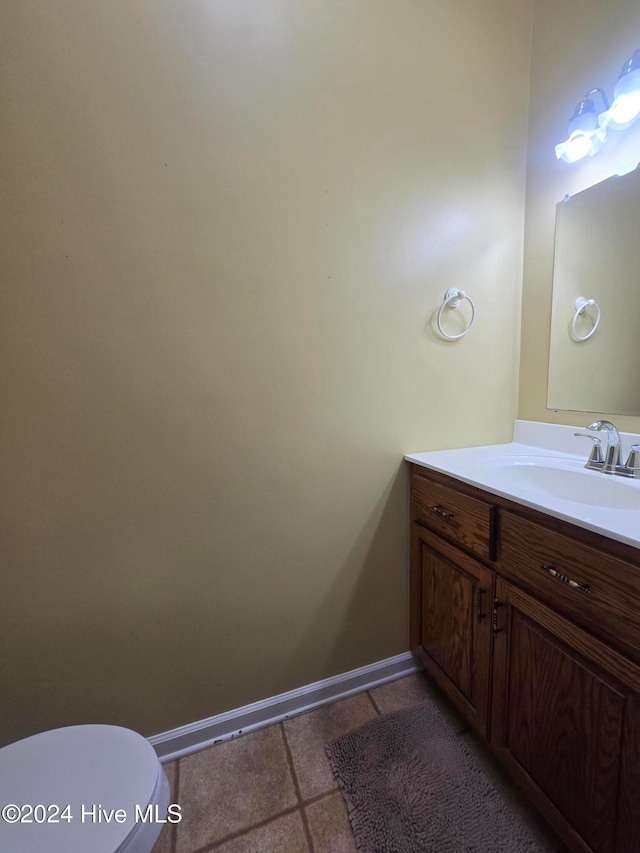 bathroom featuring vanity, toilet, and tile patterned flooring