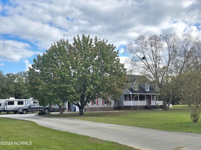 view of front facade with a front yard and a porch